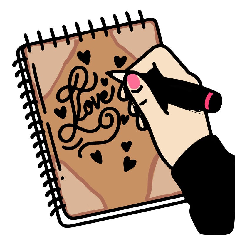 a hand writing “love” in calligraphy on a notebook