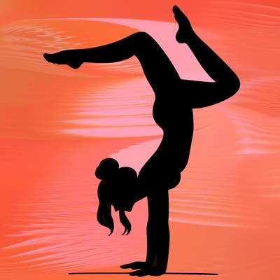 a woman doing a handstand