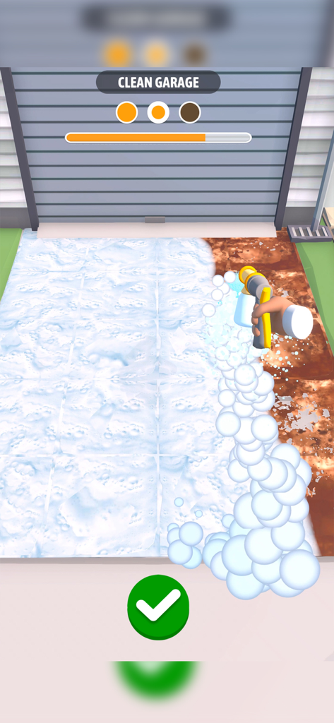 Power washing a dirty garage entrance with soap foam in the Cleaning Games mobile app