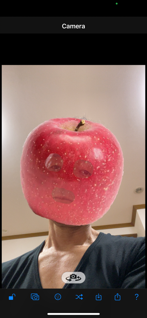 AR Mask - A person using the AR Mask app to overlay a red apple image as a digital mask on their face.