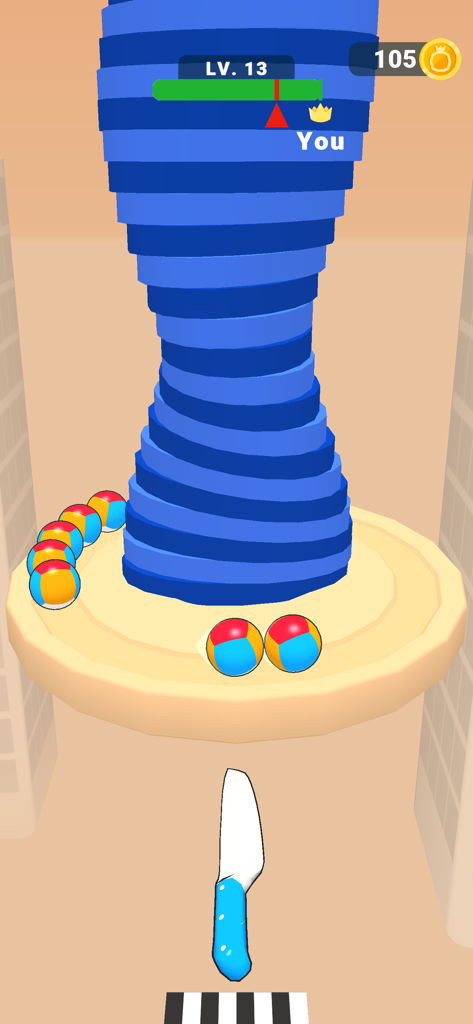 Ball Up: Knife Racing - Ball Up Knife Racing gameplay screen showing beach balls circling a blue tower with a knife at the bottom