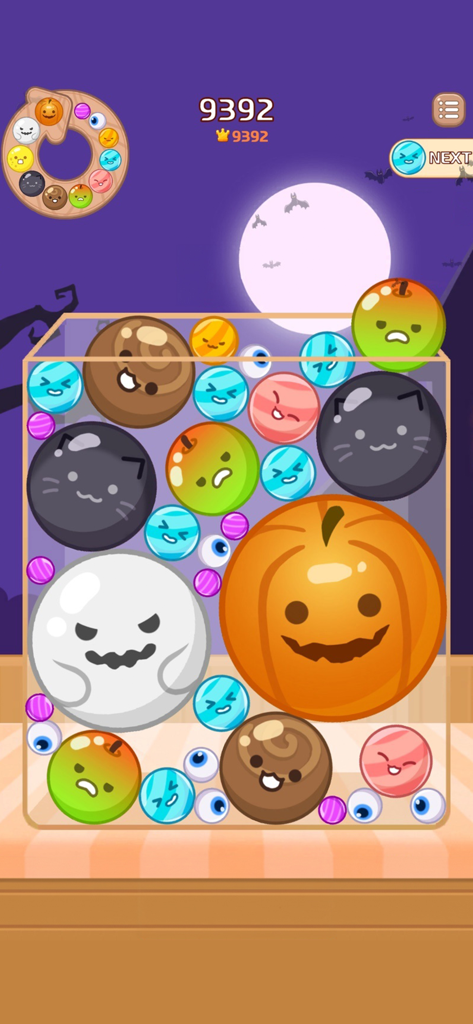 Gameplay of Melon Maker showing Halloween themed items like ghosts and pumpkins being merged in a puzzle container