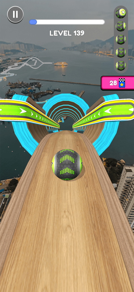Gameplay of Going Balls showing a ball rolling on a narrow wooden track over a harbor city.