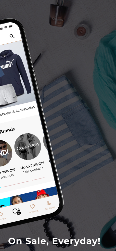 OZSALE - A smartphone displaying the OZSALE app with various designer brand sales and discounts.