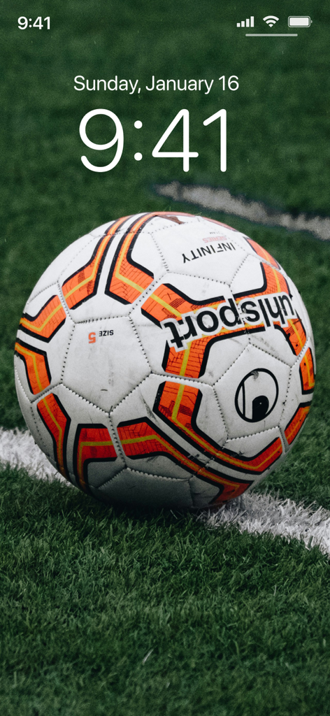 Football Wallpapers 4K | HD - A professional soccer ball on a green field used as a high definition smartphone lock screen wallpaper