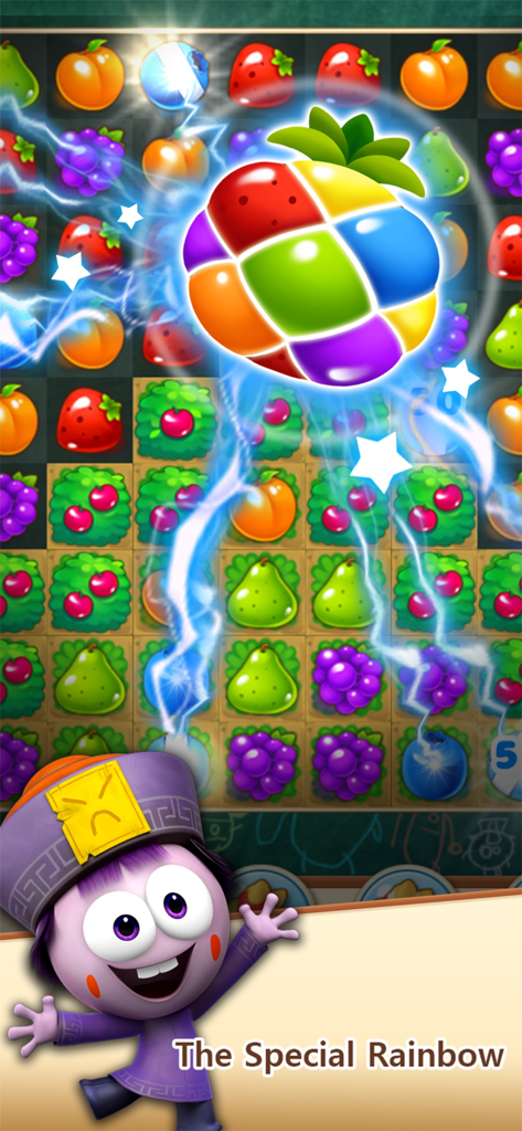 A match 3 puzzle board from SPOOKIZ POP showing a special rainbow fruit power up with lightning effects and a character at the bottom