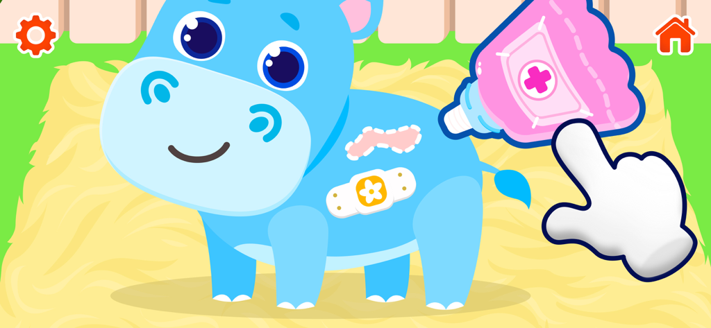 Animal Hospital — Baby Games - A toddler game screen showing a blue hippo receiving medical care with ointment and a bandage