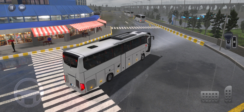 Gameplay of Bus Simulator Ultimate showing a white bus at a terminal in rainy weather