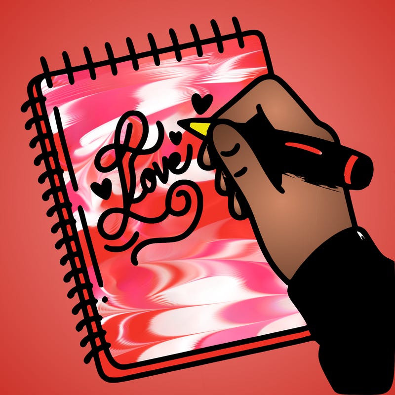 a hand writing “love” in calligraphy on a notebook