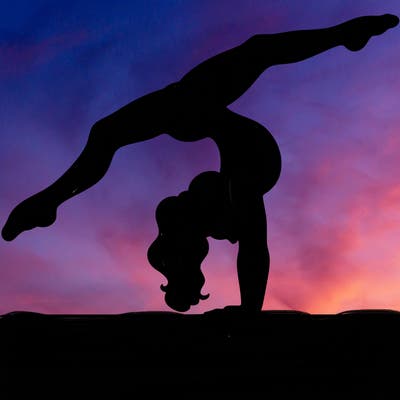 gymnast doing split handstand on a beam