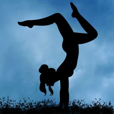 a woman doing a handstand