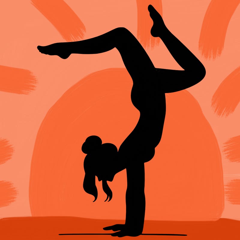 a woman doing a handstand