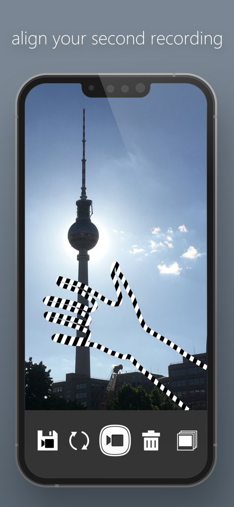 タワーに重ねられたストライプの手の形をしたオーバーレイで、2番目のビデオ録画を位置合わせしているMoshUpアプリのインターフェースが表示されている携帯電話の画面