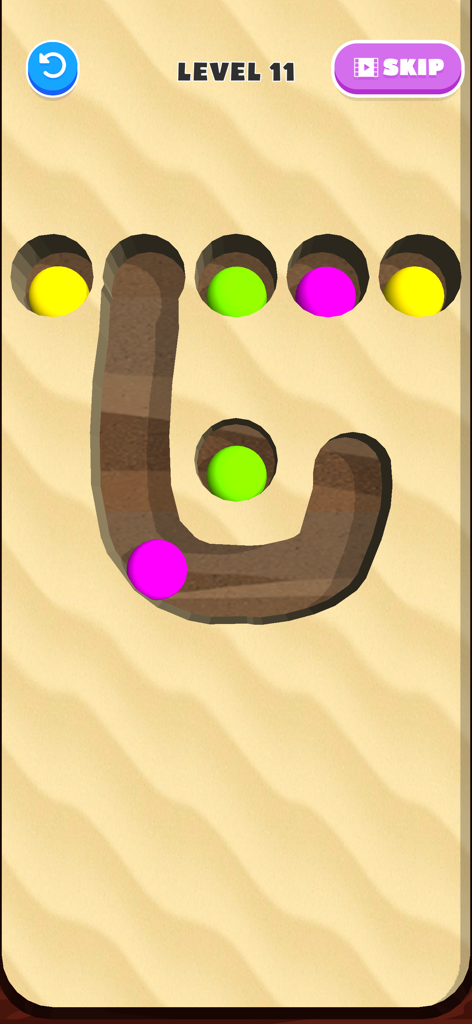 Brain Dig - Digging Puzzle - - A screen showing colorful balls in sand with hand-drawn paths in a digging puzzle game.