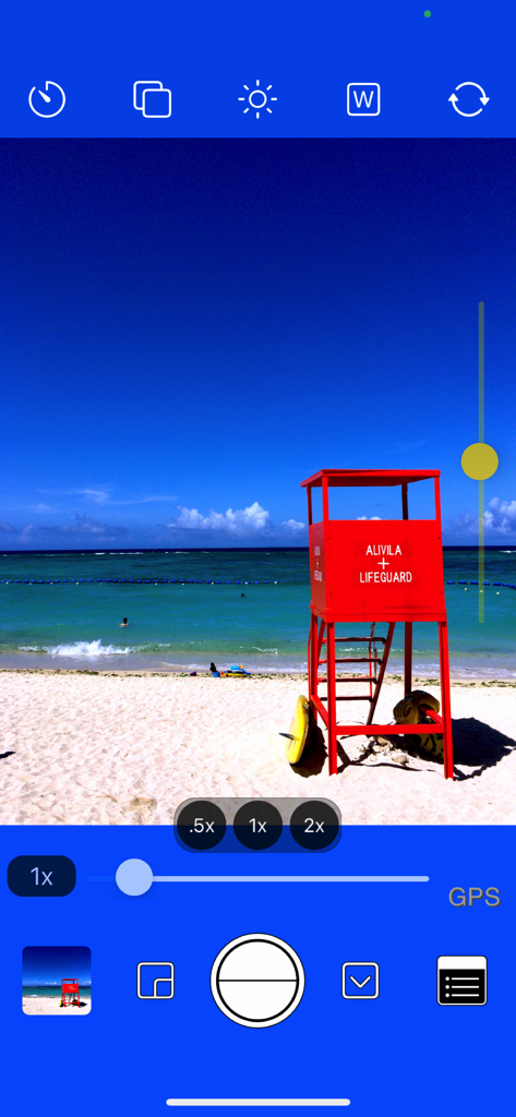 OneCam 2 camera app interface featuring manual exposure controls and lens magnification settings over a beach photo