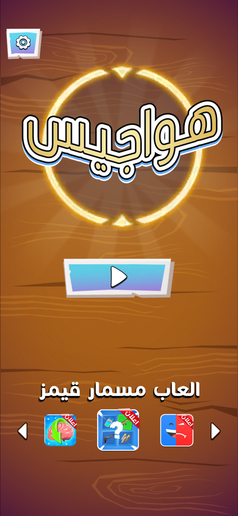 لعبة هواجيس - Home screen of the Hawajis social challenge game with a large play button and wooden background.
