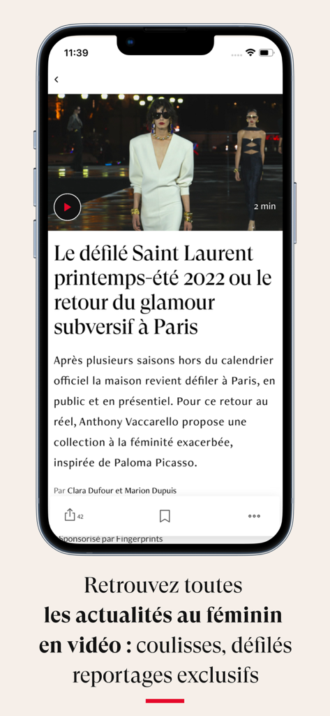 Écran d'une application mobile affichant un article de mode sur un défilé Saint Laurent à Paris, avec un bouton de lecture vidéo.