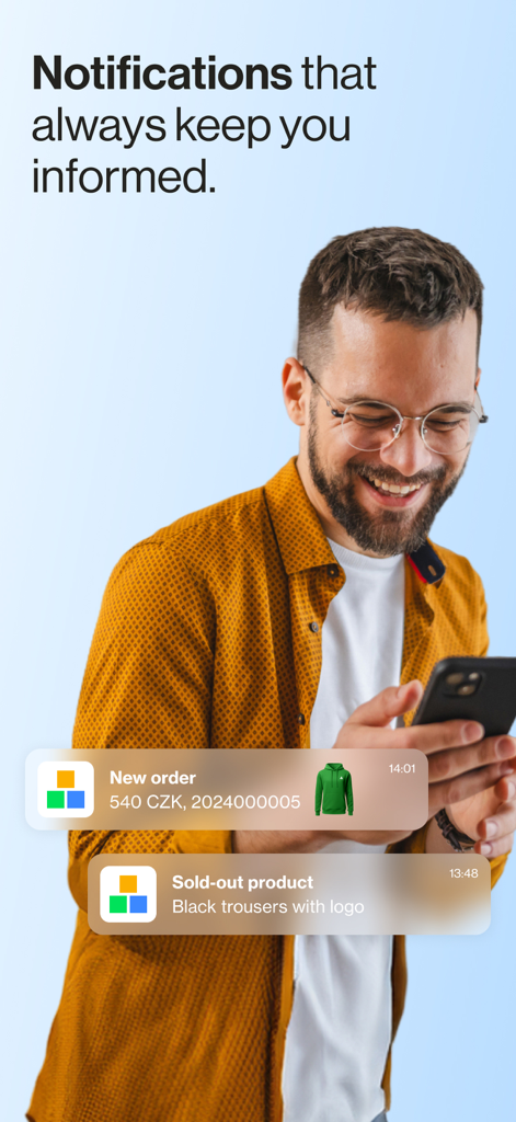Shoptet - A smiling man looking at mobile push notifications for a new e-commerce order and sold out product alerts