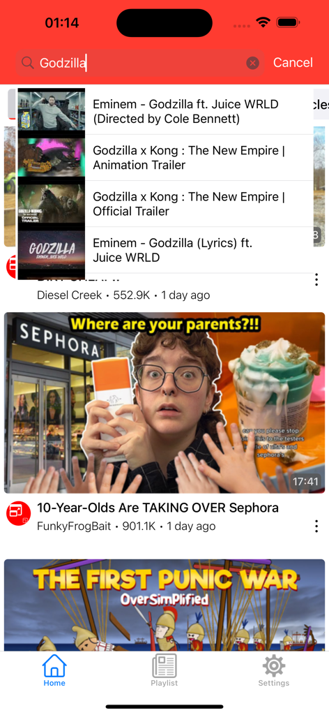 Home screen of the YouTube player app showing search suggestions for Godzilla and a list of recommended videos