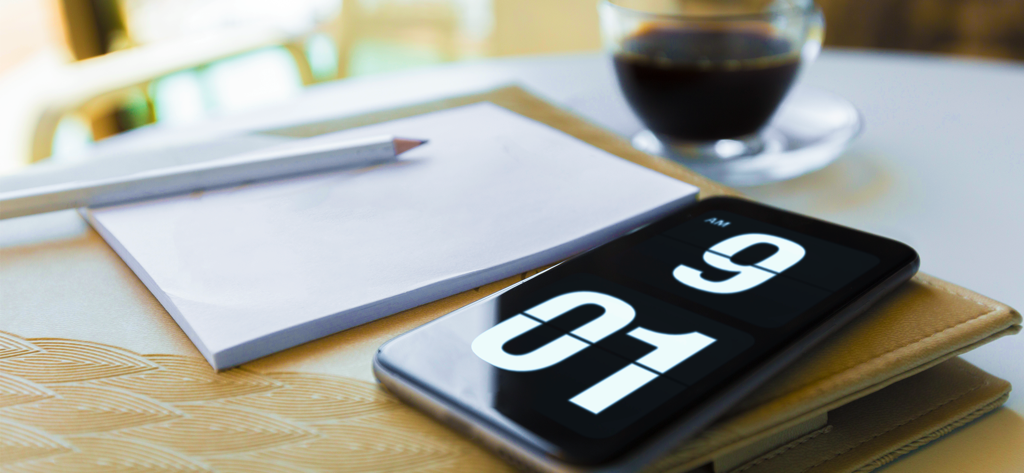 Fliqlo - Fliqlo flip clock app on a smartphone screen in a minimalist desk setup