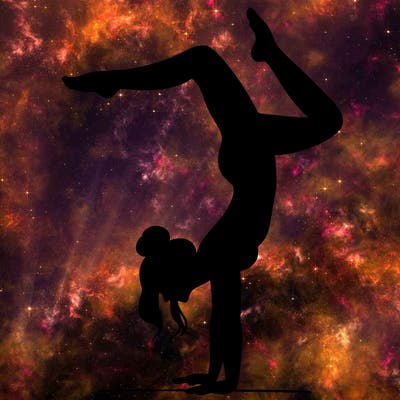 a woman doing a handstand