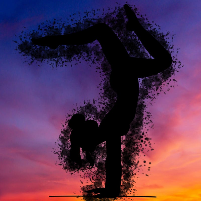 a woman doing a handstand