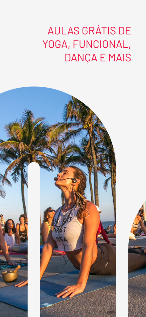 A woman teaching an outdoor yoga class at a scenic tropical location with palm trees