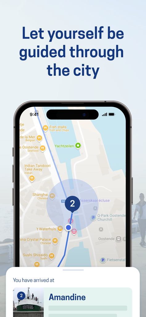 Ostend City Walks - Smartphone displaying a city map with a walking route and a notification showing arrival at the Amandine museum in Ostend