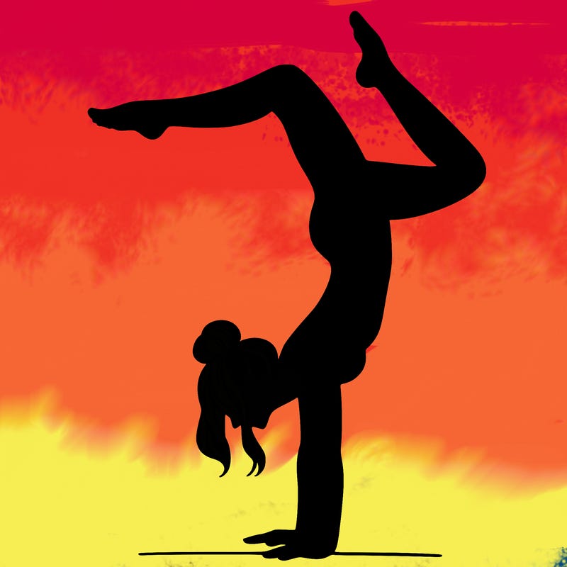 a woman doing a handstand