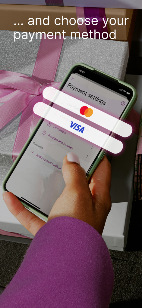 A person holding a smartphone using the EasyPark app to select a payment method including Visa and Mastercard options.