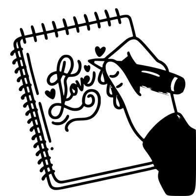 a hand writing “love” in calligraphy on a notebook