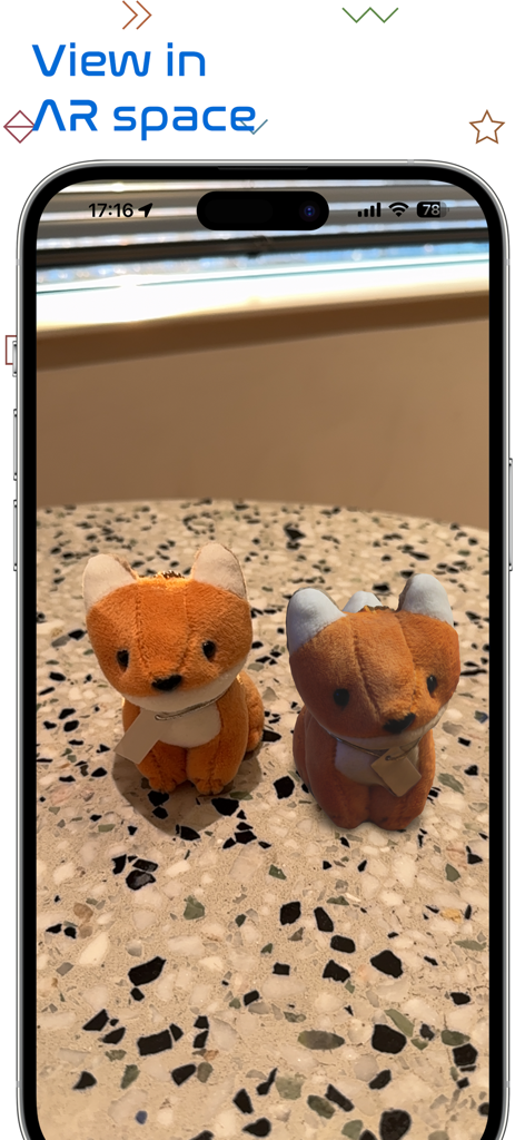 iPhone画面に、2匹のキツネのぬいぐるみの3Dモデルが拡張現実でプレビュー表示されています