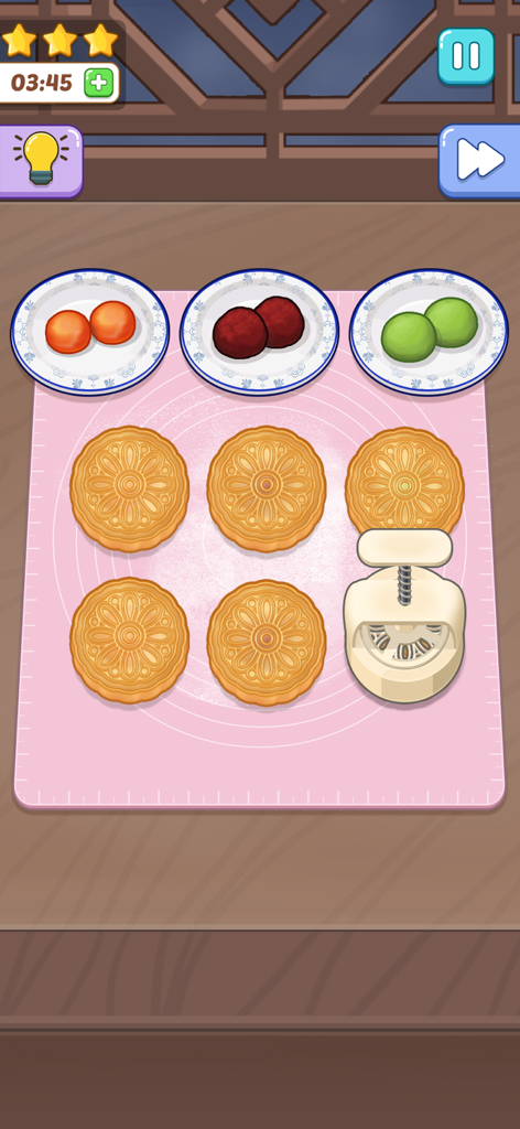 Cooking Paradise: DIY Food - A cozy mobile game screen showing mooncakes being prepared with a press and colorful fillings on a pink mat.