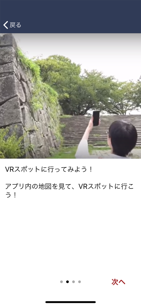 StreetMuseum(LocationedVR) - A user viewing historical VR content on a smartphone at a Japanese castle wall.