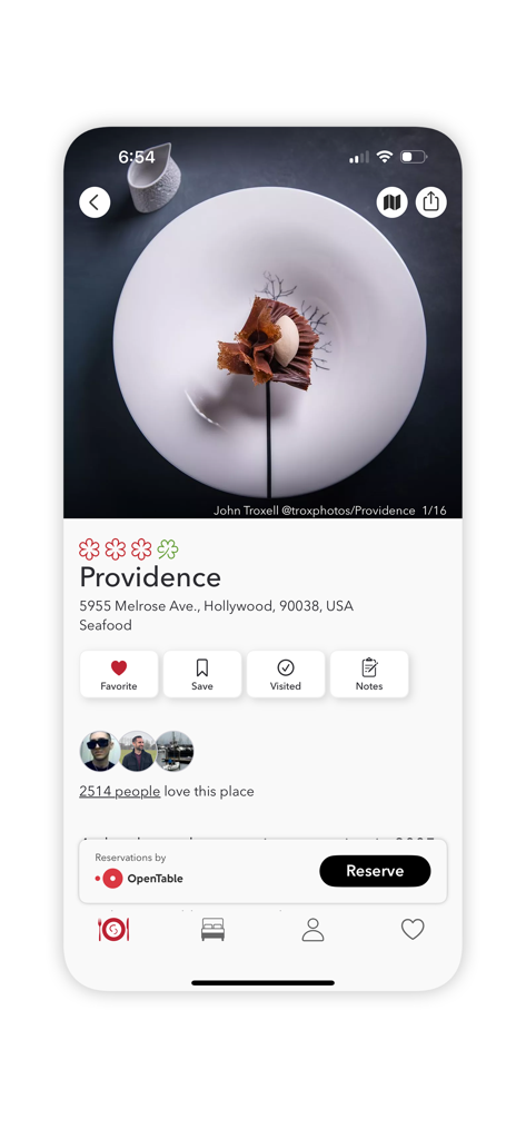 The MICHELIN Guide - Una página de perfil de restaurante para Providence en Hollywood dentro de la aplicación La Guía Michelin, mostrando un plato de alta cocina y opciones de reserva.