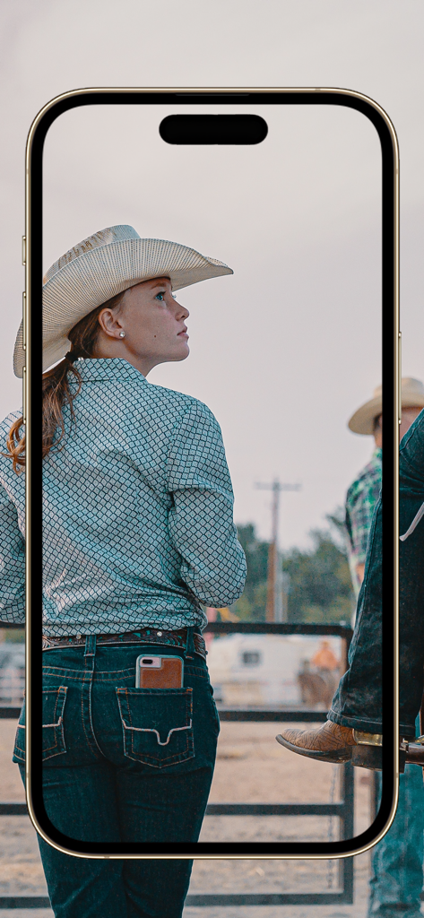 Equestrian App - A female horse rider wearing a cowboy hat at an equestrian facility