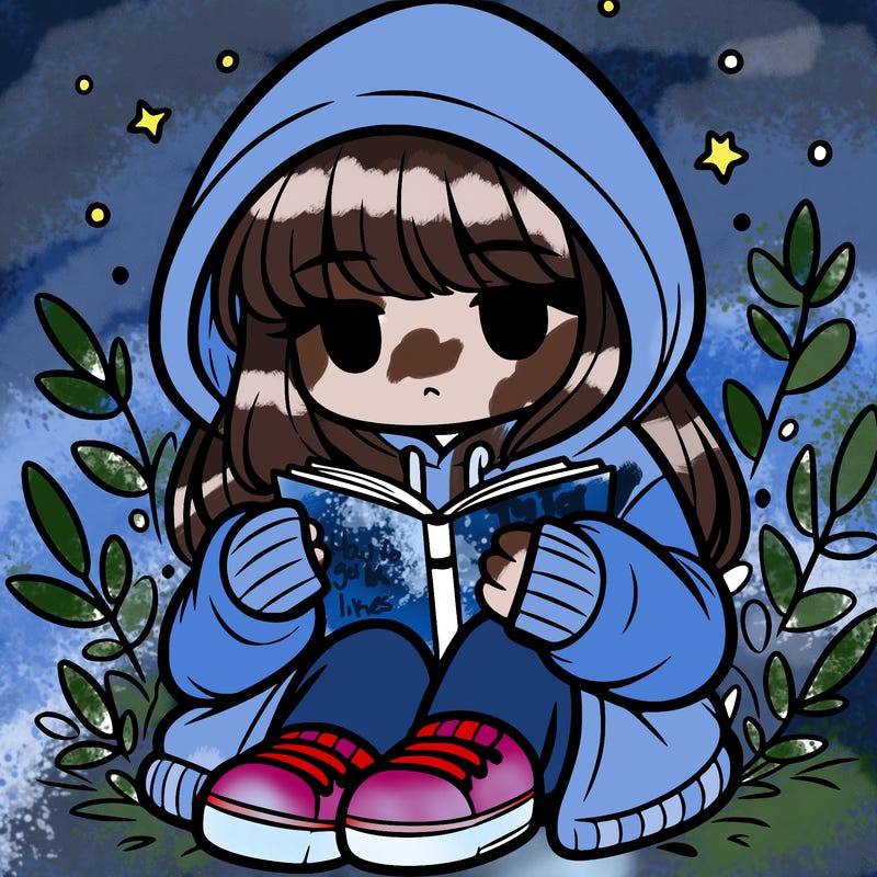 girl in oversized hoodie reading a book