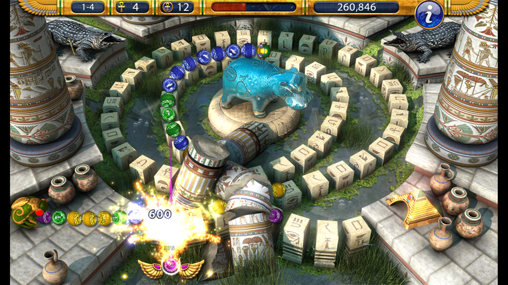 Luxor 2 - Gameplay screenshot of Luxor 2 showing a winged scarab shooting colored marbles in an ancient Egyptian temple setting with explosive effects