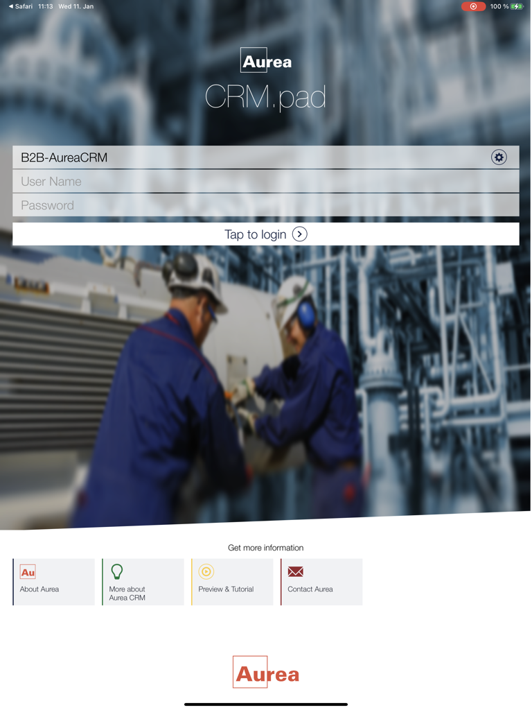 CRMpad Legacy - Login screen for the CRMpad Legacy iPad application with industrial workers in the background