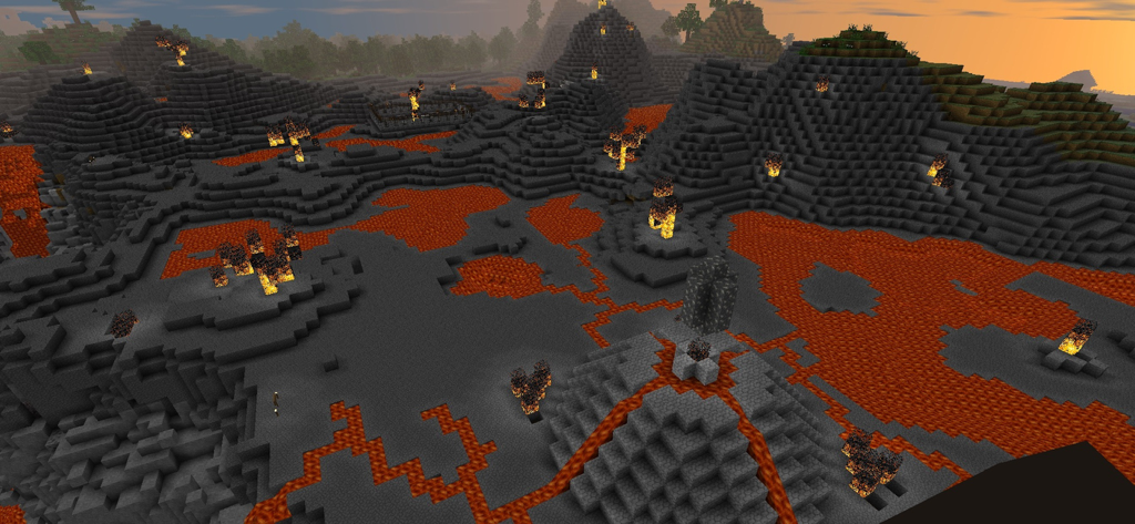 Survivalcraft 2 Day One - Un ambiente 3D a blocchi in Survivalcraft 2 con colline rocciose grigio scuro e pozze di lava arancione che scorrono sotto un cielo al tramonto