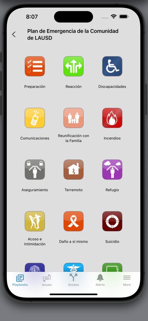 LAUSD EM - A mobile phone screen displaying the LAUSD EM app Spanish menu with icons for earthquake, fire, and other emergency procedures.