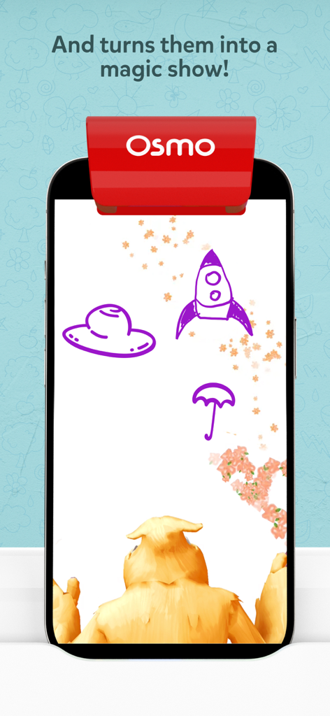 A smartphone screen showing the Osmo Monster app with drawings of a rocket and umbrella being animated