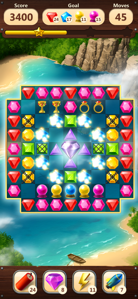 Jewels Planet  - Match 3 Game - A match 3 puzzle board from Jewels Planet featuring colorful gems and special items set against a tropical beach background.