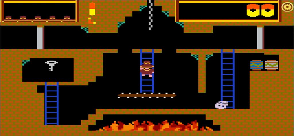 Montezumas Revengeの公式8ビットレトログラフィックゲームプレイ。キャラクターが火と鍵のあるピラミッドの部屋の梯子を登っています。