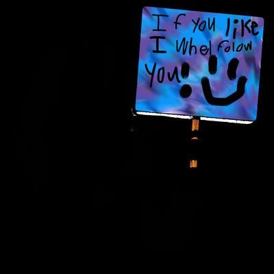 realistic girl holding up a sign