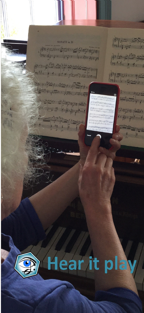 A person using a smartphone to scan and play back sheet music on a piano