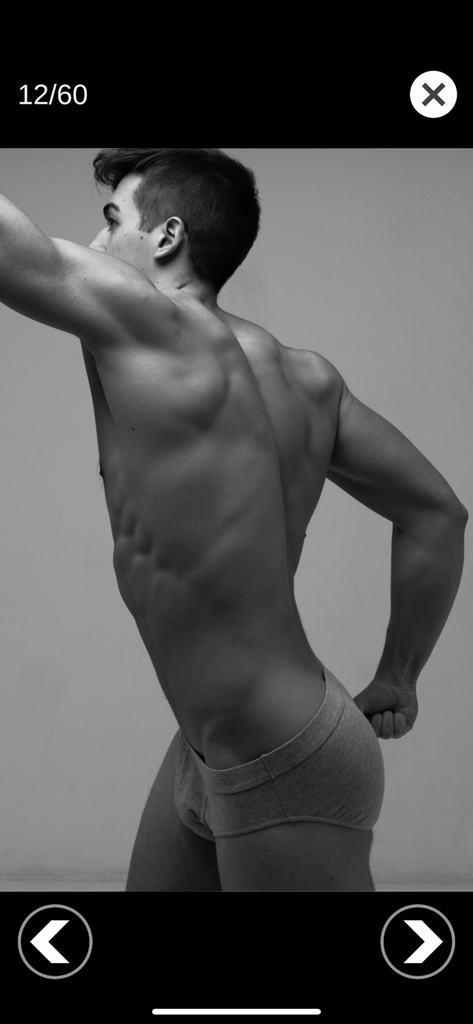 A black and white photo of a male torso showing muscle definition for anatomical drawing reference.