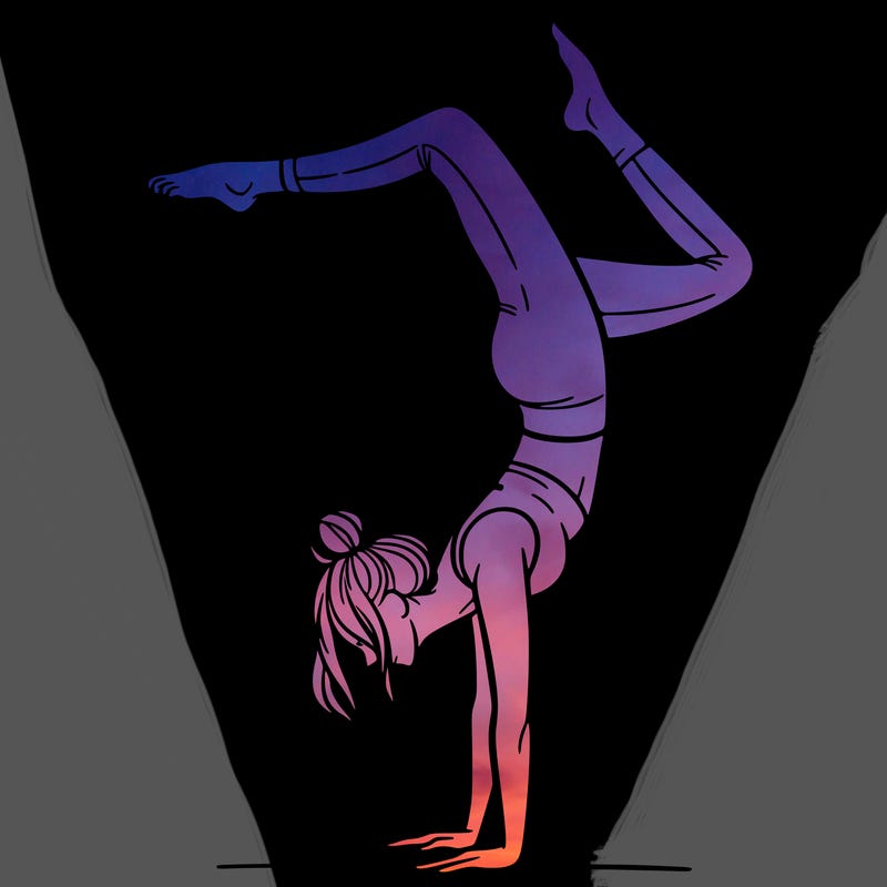 a woman doing a handstand