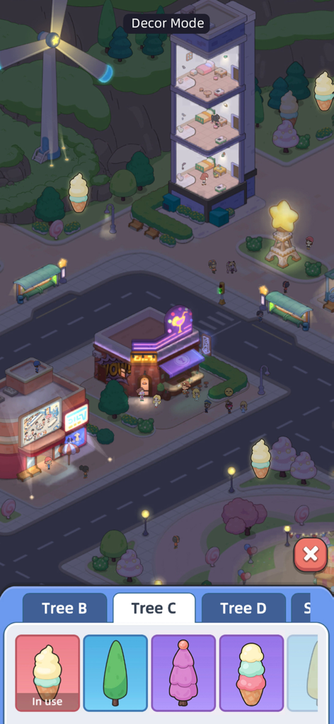 A screenshot of Happy Citizens Mayor Sim showing the city decoration mode with whimsical tree options and glowing buildings at night.