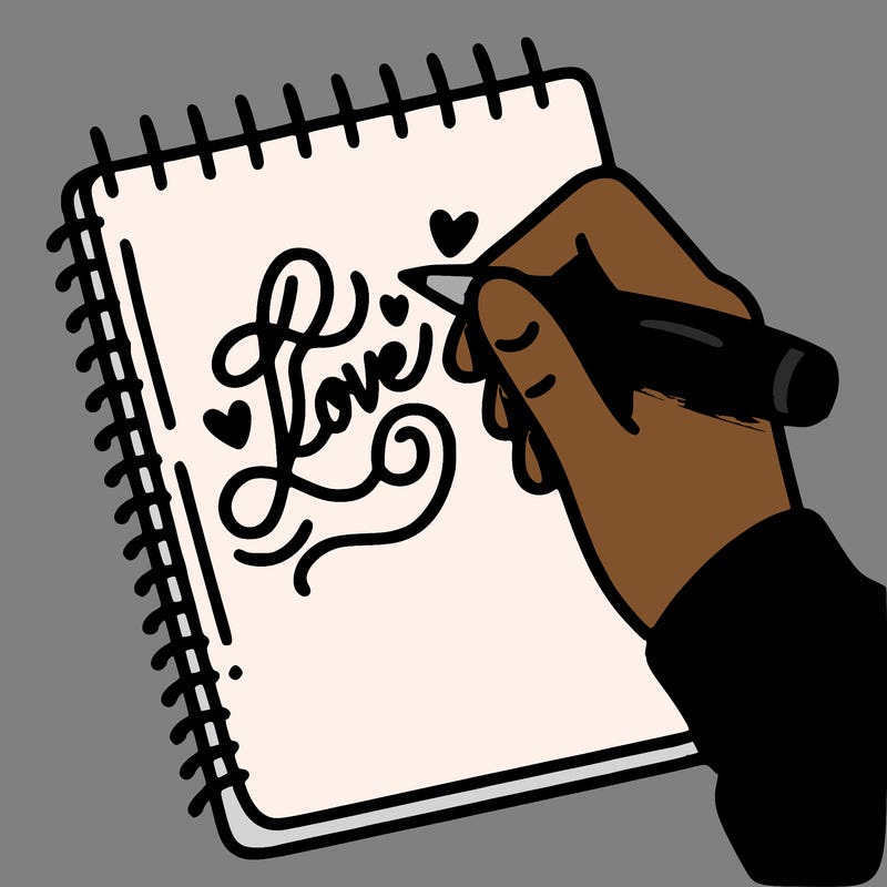 a hand writing “love” in calligraphy on a notebook